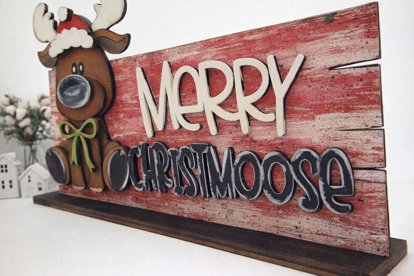 Hand painted layered wood Christmas moose shelf sitter featuring a whimsical “Merry Christmoose” design. Rustic holiday décor perfect for mantles, tiered trays, and winter farmhouse styling. Unique handmade Christmas decoration.