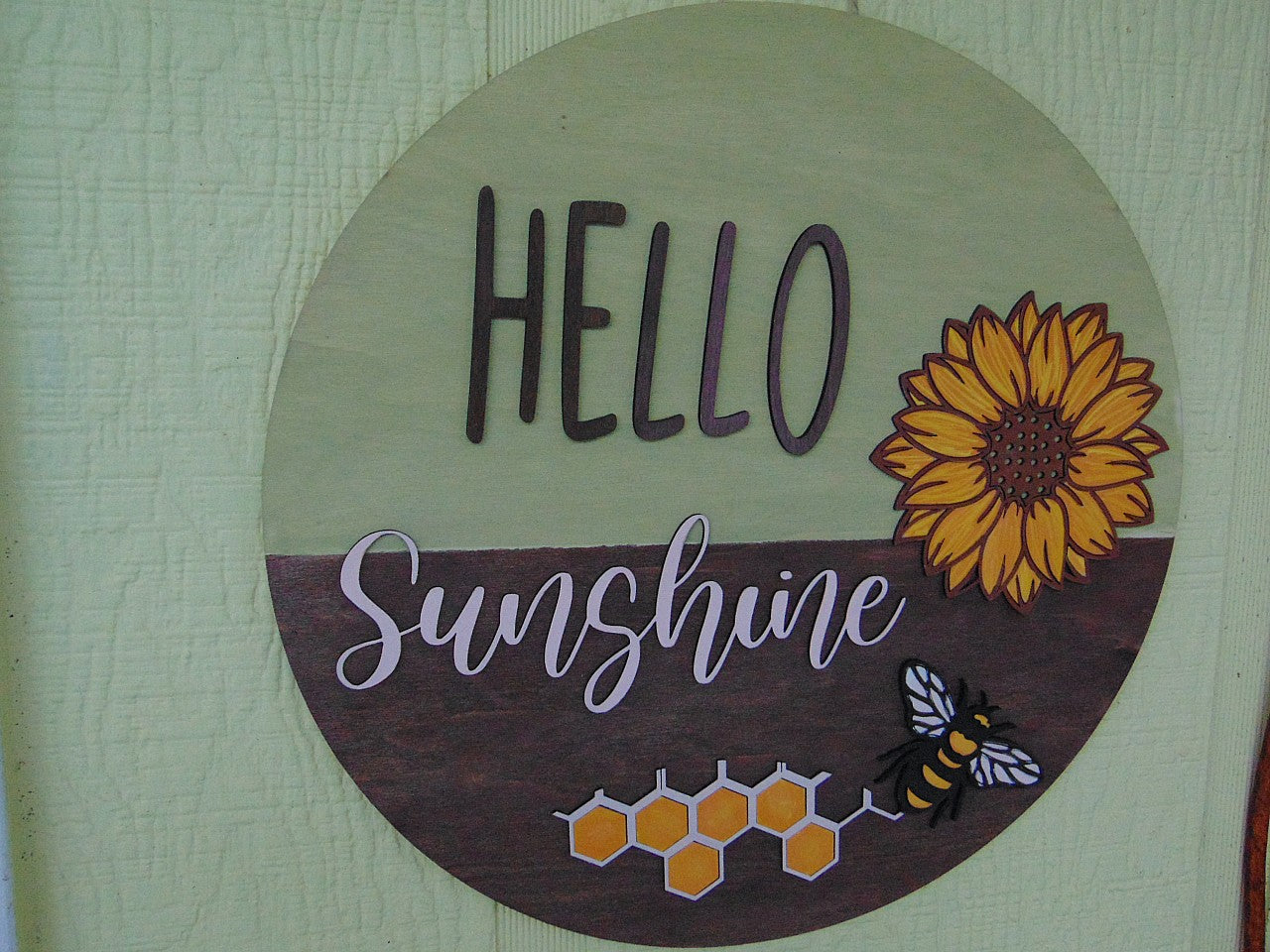 Brighten up your entryway this summer with our charming "Hello Sunshine" Sunflower Bee Door Hanger! This delightful piece is perfect for adding a touch of warmth and cheer to your front door, porch, or any space in your home. Each door hanger is lovingly handcrafted, ensuring that every piece is unique and may vary slightly from the picture, adding a personal touch to your decor.