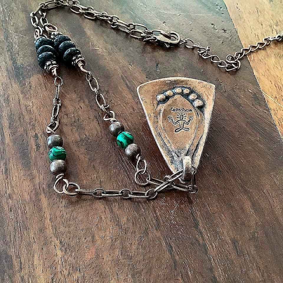 Wrap yourself in the irresistible beauty of nature with our Malachite Pendant Necklace. Handcrafted from pure copper and showcasing a stunning malachite gemstone cabochon, this gorgeous necklace is sure to be a conversation starter. Accented with malachite, volcanic rock, and copper beads- CosmicDeva