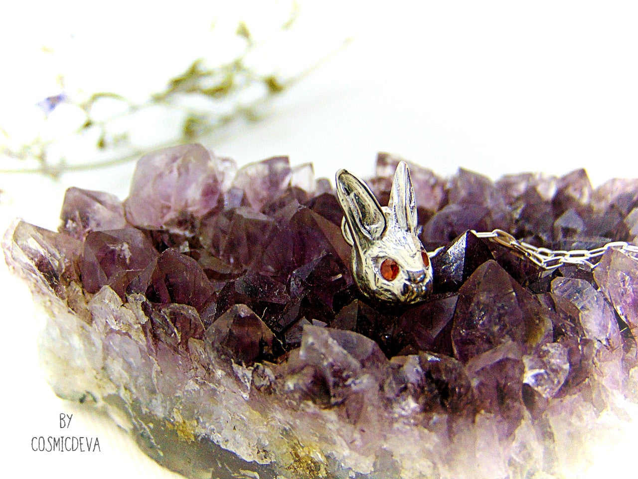 Handmade dainty small little rabbit 🐰 made of solid sterling silver with tiny faceted lab created fire opal eyes. Lab created stones are chemically, physically and optically identical to those mined underground. This cute little bunny dangles from a delicate 18 inch solid .925 sterling silver flat cable 1.4mm chain necklace.
