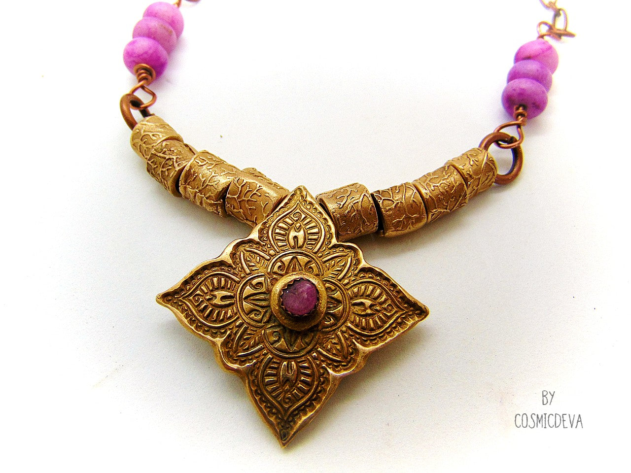 Enliven your wardrobe with this stunning Pink Tourmaline Mandala Mehndi Gold Bronze Necklace! Crafted with a unique hand formed bronze mandala pendant, pink tourmaline gemstone, and lovely pink jasper rondelle beads, this piece is perfect for yoga meditations or everyday wear. Adorn yourself with inspiring beauty!