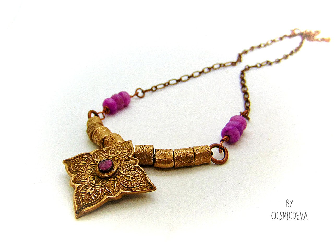 Enliven your wardrobe with this stunning Pink Tourmaline Mandala Mehndi Gold Bronze Necklace! Crafted with a unique hand formed bronze mandala pendant, pink tourmaline gemstone, and lovely pink jasper rondelle beads, this piece is perfect for yoga meditations or everyday wear. Adorn yourself with inspiring beauty!