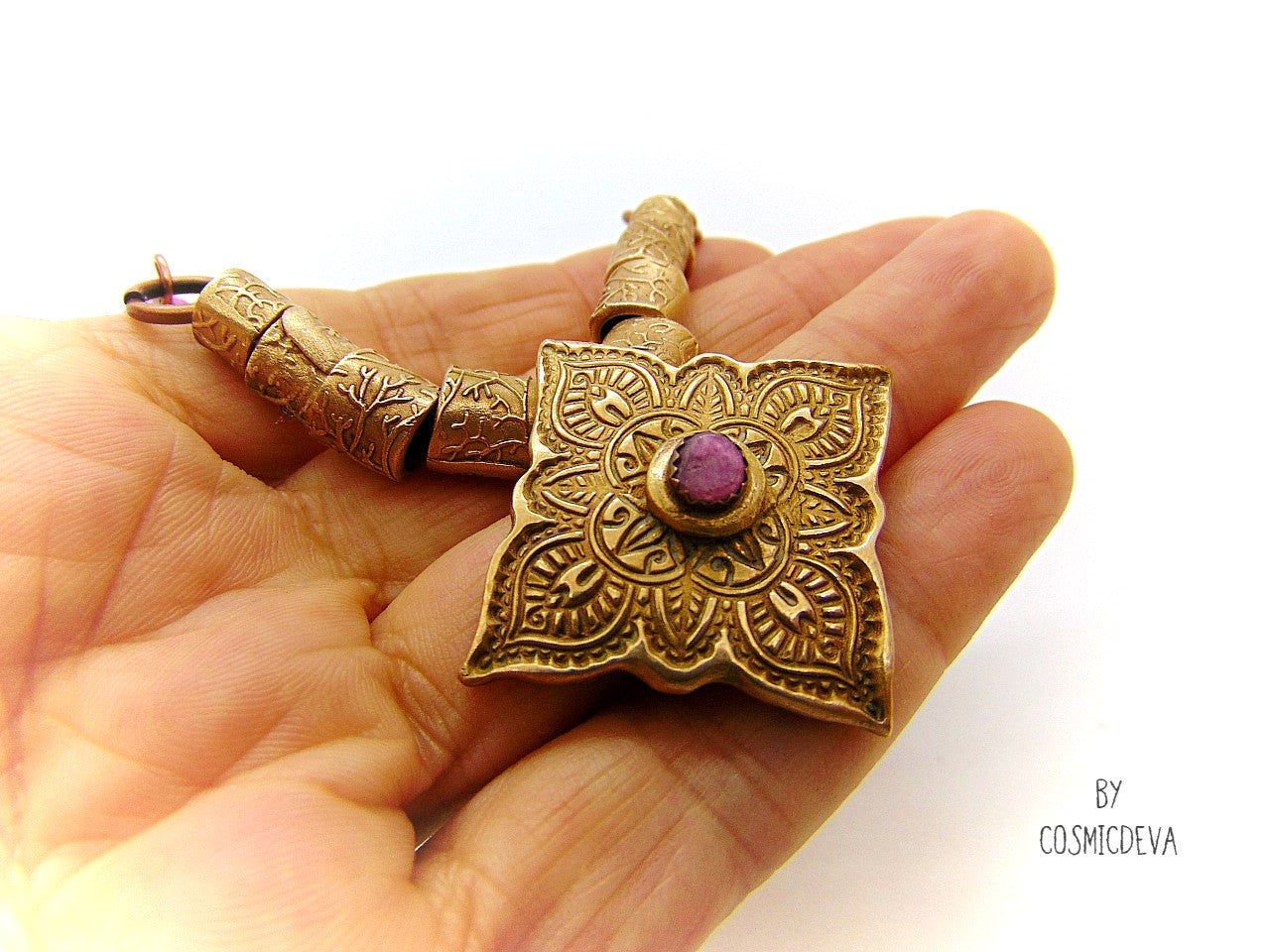 Enliven your wardrobe with this stunning Pink Tourmaline Mandala Mehndi Gold Bronze Necklace! Crafted with a unique hand formed bronze mandala pendant, pink tourmaline gemstone, and lovely pink jasper rondelle beads, this piece is perfect for yoga meditations or everyday wear. Adorn yourself with inspiring beauty!