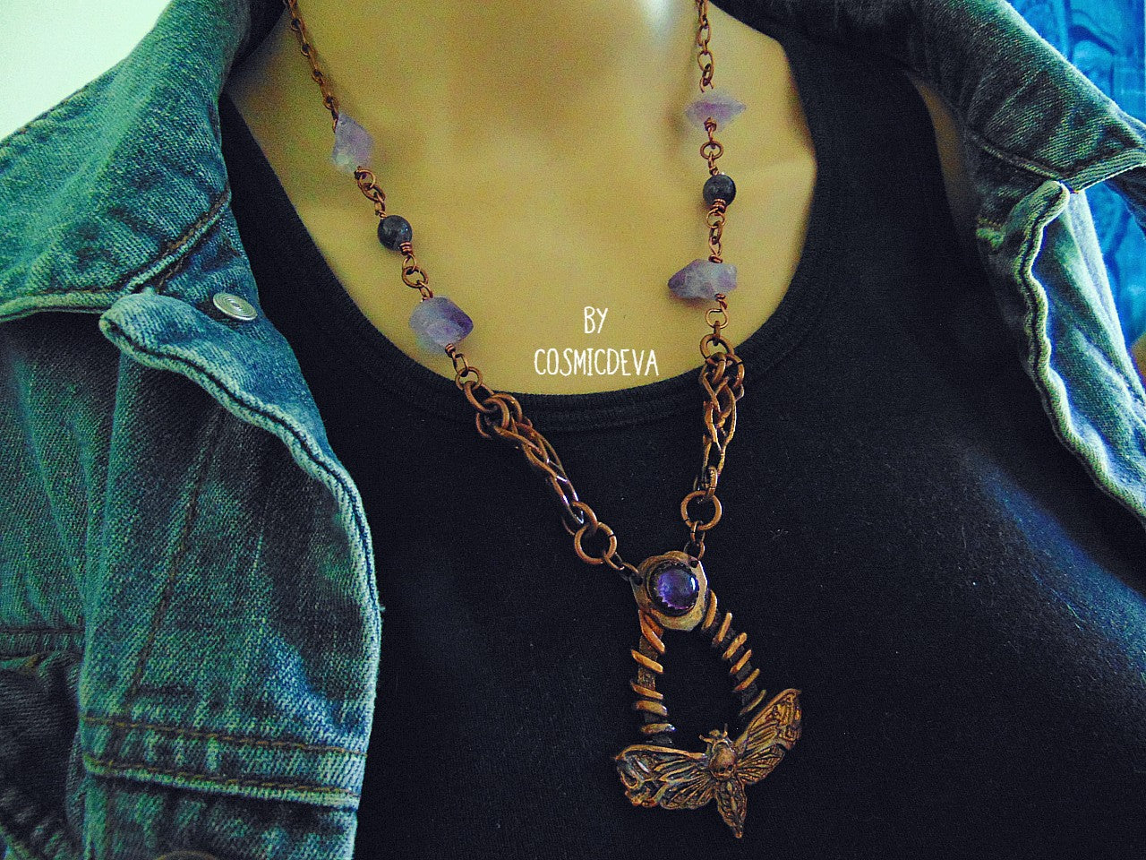 Handcrafted detailed death head hawk Moth (Acherontia) made of solid copper with a natural amethyst cabochon setting. The pendant is the focal point of a chain necklace with drilled natural raw amethyst gemstones, natural amethyst round beads and two completely handcrafted copper Celtic knot design findings.