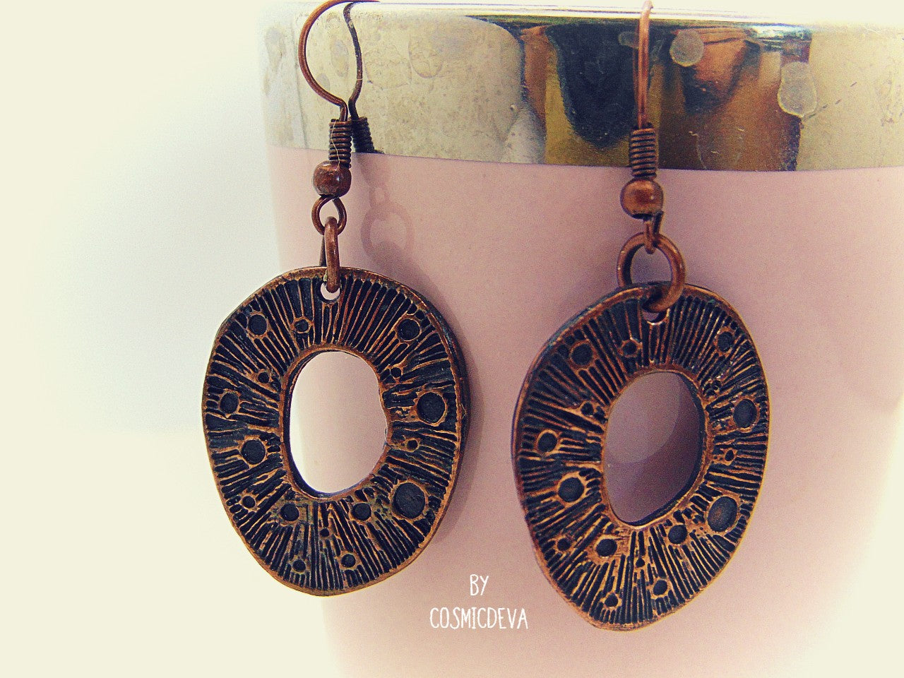 These organic copper dangle earrings are the perfect pick for any season. Handcrafted in the studio, they feature a unique organic texture and warm patinated copper color that can't be found anywhere else. Lightweight and comfortable to wear, no two pairs are ever alike!