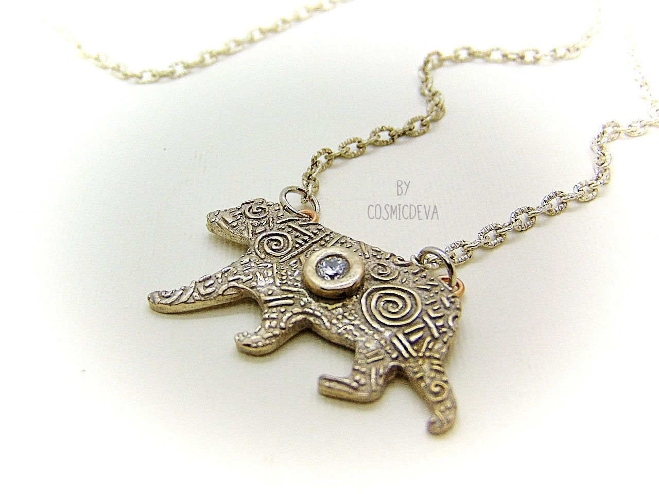 Inspire yourself to be strong and graceful like a polar bear with this handcrafted Silver Bear Spirit Animal Pendant Bronze Necklace. Crafted with a kiln fired silver bronze bear, accented with a diamond cut cubic zirconia gemstone, this pendant suspends from an 18-20 inch long chain. Wear this powerful piece and feel the power of the wild!
