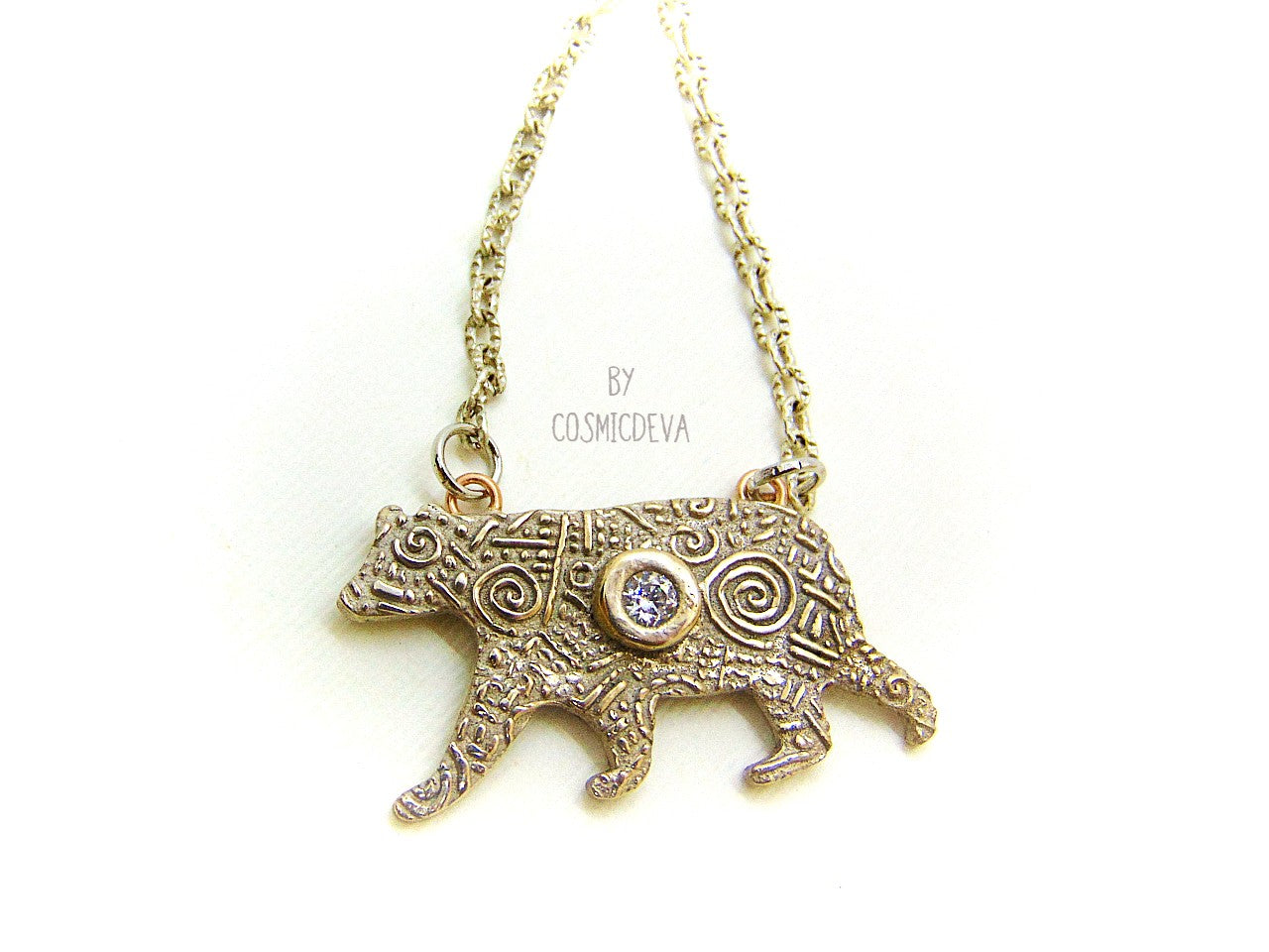 Inspire yourself to be strong and graceful like a polar bear with this handcrafted Silver Bear Spirit Animal Pendant Bronze Necklace. Crafted with a kiln fired silver bronze bear, accented with a diamond cut cubic zirconia gemstone, this pendant suspends from an 18-20 inch long chain. Wear this powerful piece and feel the power of the wild!