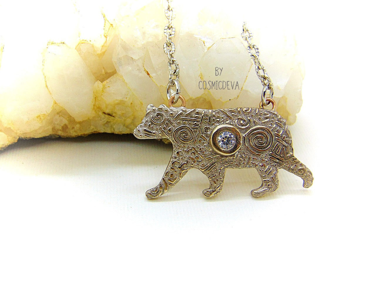 Inspire yourself to be strong and graceful like a polar bear with this handcrafted Silver Bear Spirit Animal Pendant Bronze Necklace. Crafted with a kiln fired silver bronze bear, accented with a diamond cut cubic zirconia gemstone, this pendant suspends from an 18-20 inch long chain. Wear this powerful piece and feel the power of the wild!