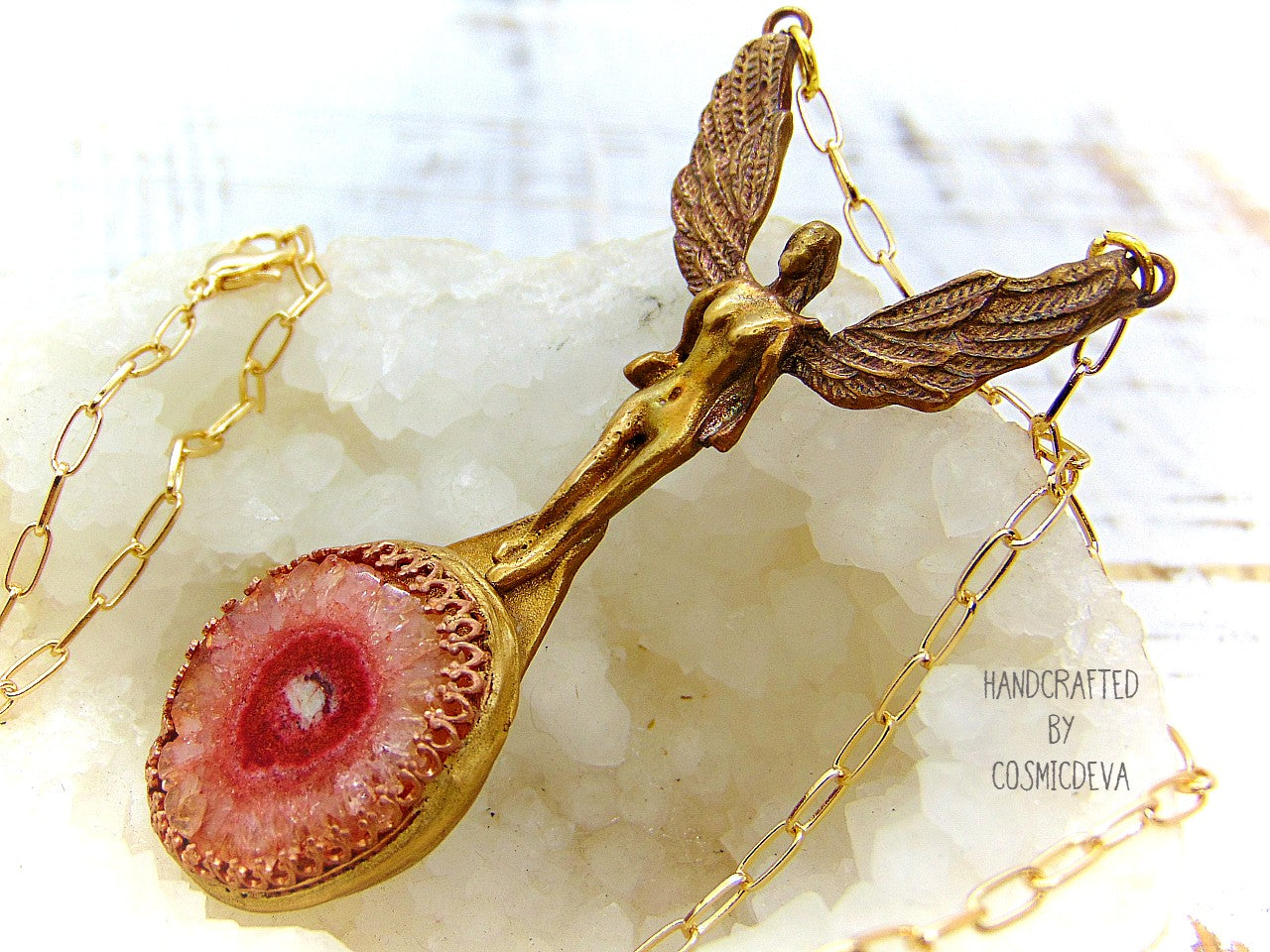 Be divinely inspired wearing this unique Archangel Chamuel pendant necklace. Handcrafted from gold bronze, it features a pink solar quartz bezel setting and is charged with the pink angel light ray of Kamael, the Archangel of peaceful relationships. Energize your spirit and look beautiful 