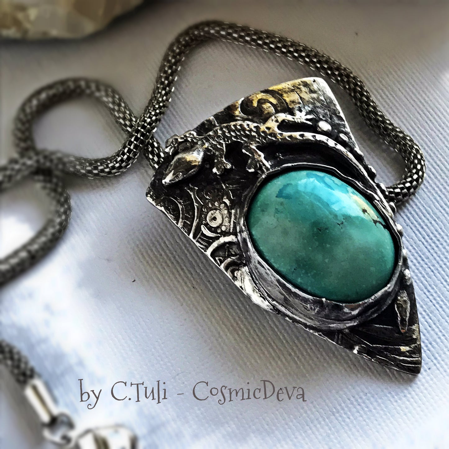Sterling Silver Lizard Gecko Turquoise Pendant Necklace. Beautiful completely handcrafted pure sterling silver pendant with a Arizona turquoise gemstone cabochon. This unique statement piece is designed with a lizard/ gecko southwest style. It is hallmarked as Sterling Silver and carries my artisan Cosmicdeva logo. The necklace is a 16 inch (40.6 cm) woven wire silver tone alloy. - CosmicDeva