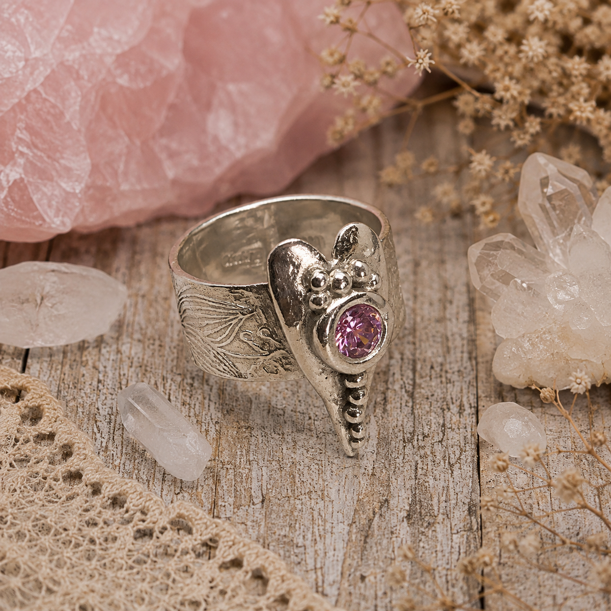 Handmade .950 sterling silver heart ring with sparkling pink CZ gemstone and floral textured wide band. Romantic boho statement ring, size 8–8.5. by Cosmicdeva 