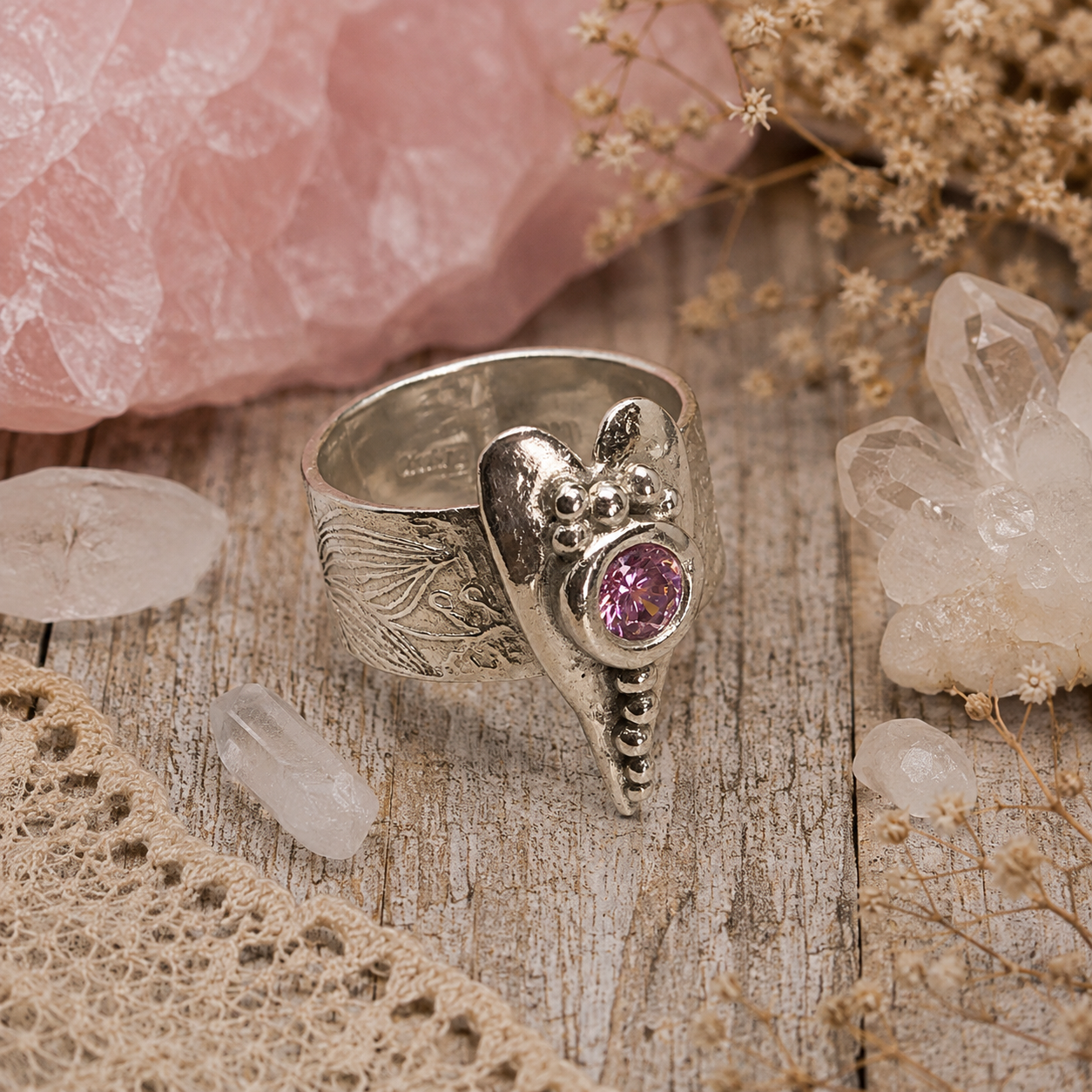 Handmade .950 sterling silver heart ring with sparkling pink CZ gemstone and floral textured wide band. Romantic boho statement ring, size 8–8.5. by Cosmicdeva 