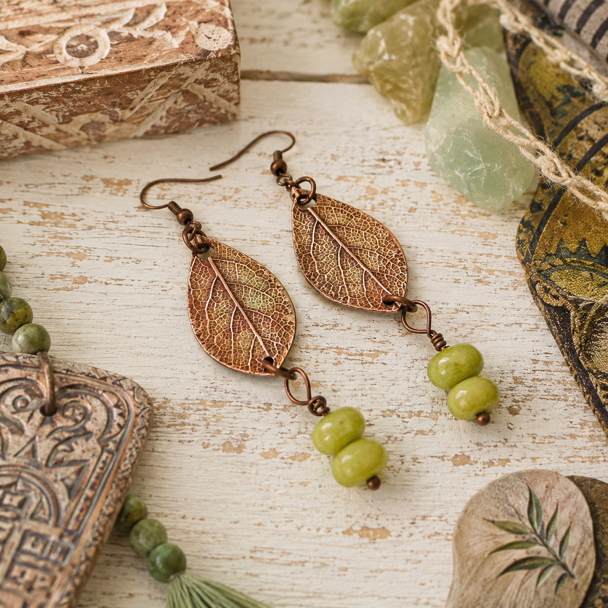 Handmade sage leaf copper earrings with apple green jade beads. Nature-inspired botanical boho earrings made in the USA—a unique gift for nature lovers. By cosmicdeva