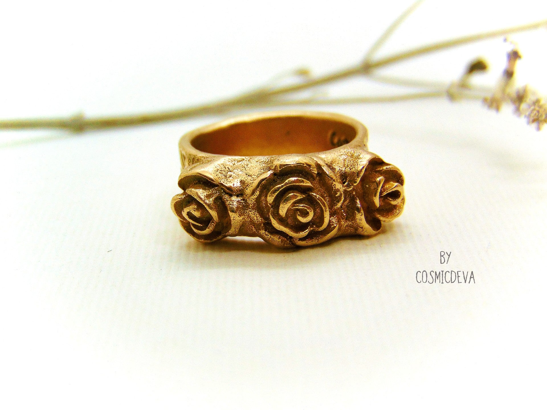 Handmade and hand formed unique organic solid gold bronze roman style ring featuring three roses with a heart 💕 on the bottom side.