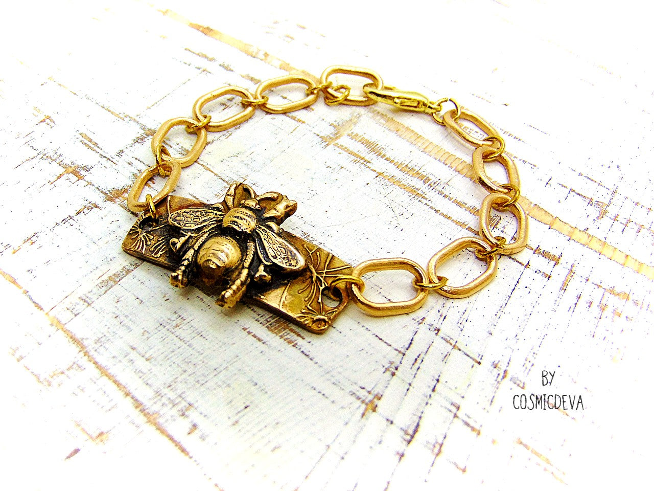 “Bee strong, Bee You, Bee Harmony” - Crafted with love and precision in our cozy Southeast Alabama home studio, this beautiful honeybee bracelet is a true work of art.  Each element, from the radiant recycled pure gold bronze honeybee charm tag to the intricate oval chain links, is individually meticulously handcrafted, hand carved and kiln fired, ensuring a piece that is as unique as it is elegant.