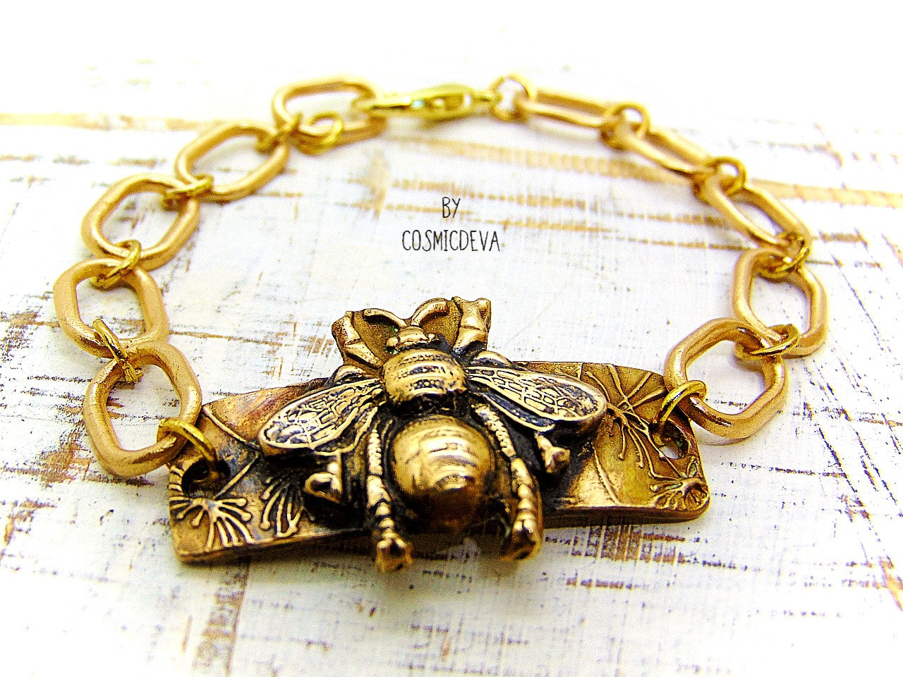 “Bee strong, Bee You, Bee Harmony” - Crafted with love and precision in our cozy Southeast Alabama home studio, this beautiful honeybee bracelet is a true work of art.  Each element, from the radiant recycled pure gold bronze honeybee charm tag to the intricate oval chain links, is individually meticulously handcrafted, hand carved and kiln fired, ensuring a piece that is as unique as it is elegant.