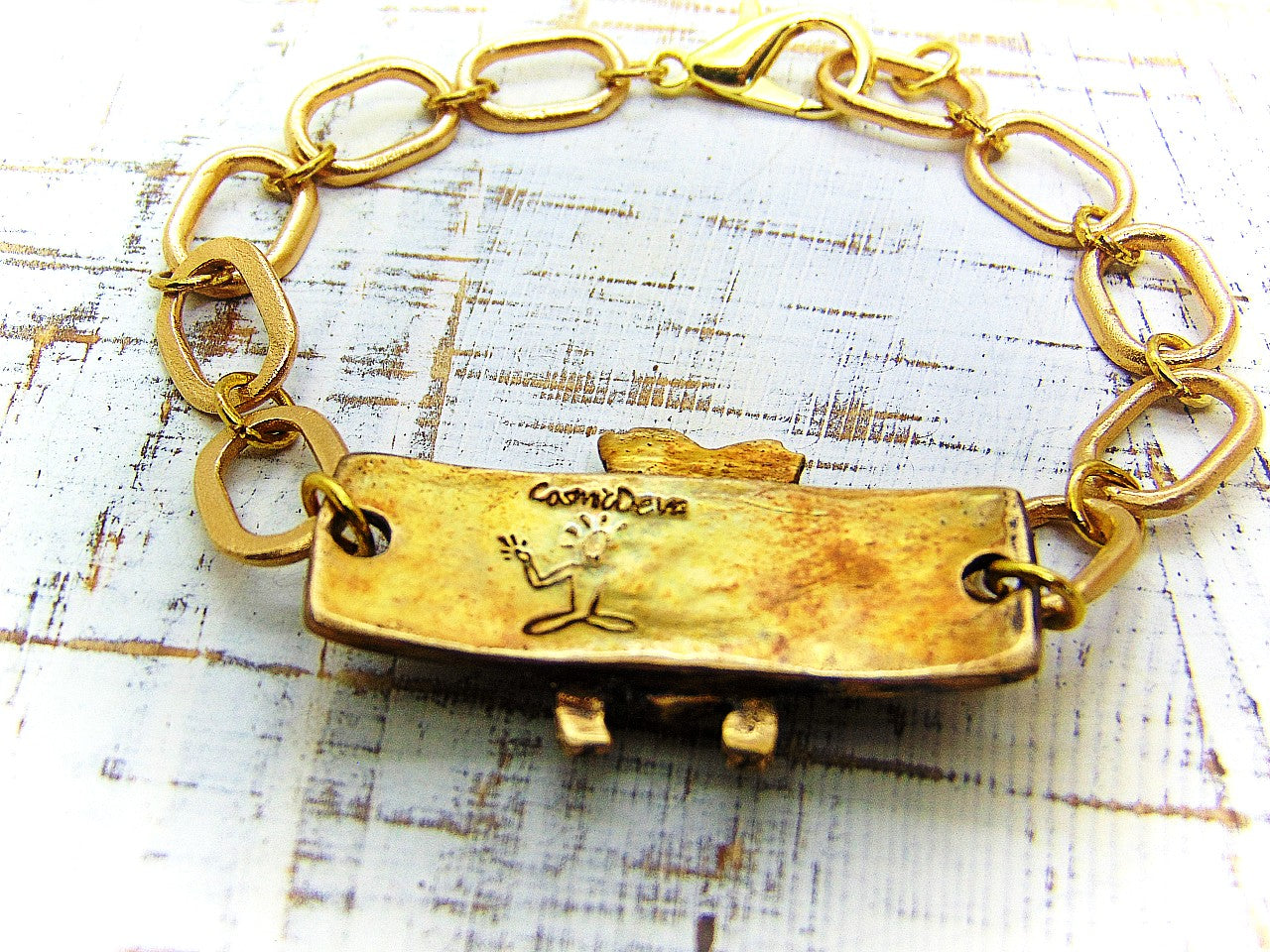 “Bee strong, Bee You, Bee Harmony” - Crafted with love and precision in our cozy Southeast Alabama home studio, this beautiful honeybee bracelet is a true work of art.  Each element, from the radiant recycled pure gold bronze honeybee charm tag to the intricate oval chain links, is individually meticulously handcrafted, hand carved and kiln fired, ensuring a piece that is as unique as it is elegant.