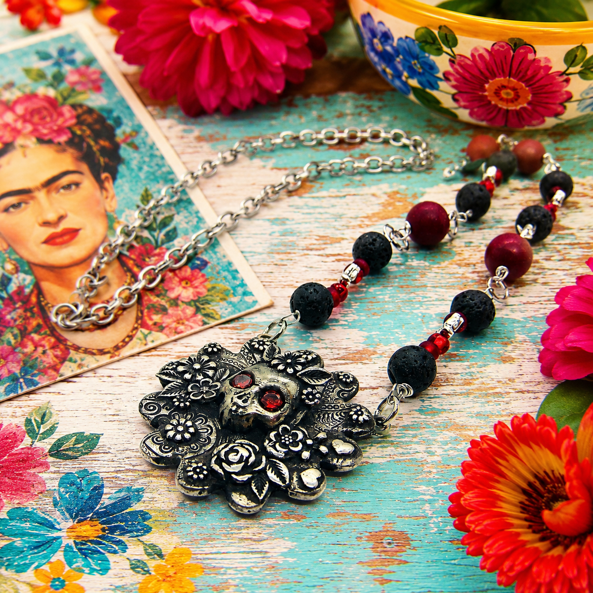 Cherish Mexican folk art with this unique Frida Kahlo sugar skull necklace, featuring a silver bronze floral pendant accented with garnet gemstones, roses, leaves and hearts.