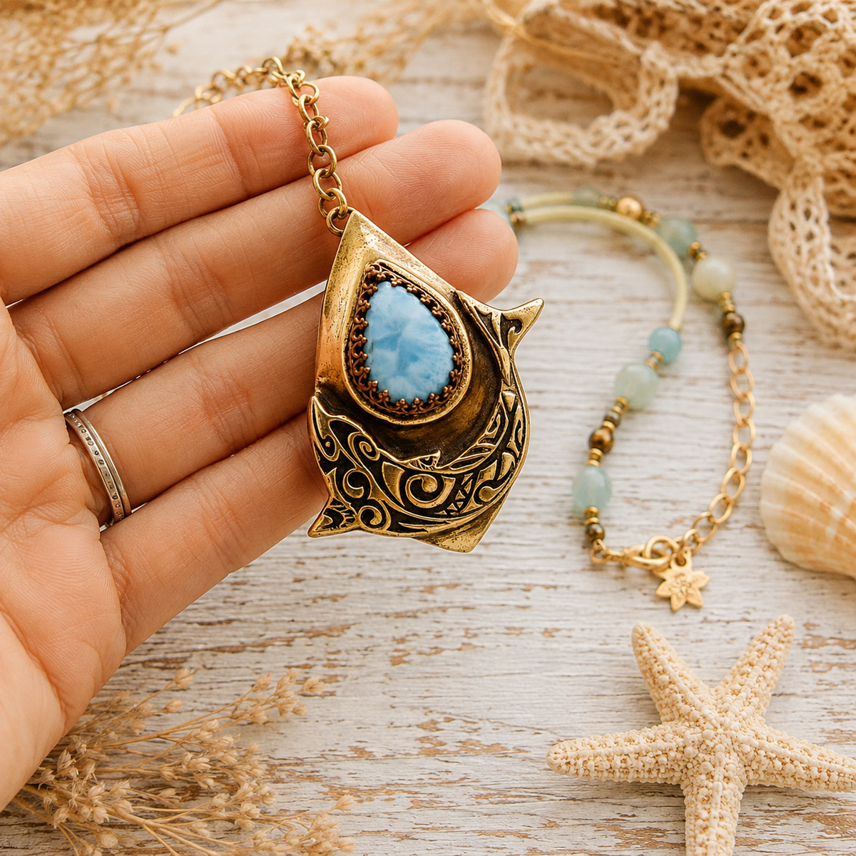 Handmade Larimar dolphin necklace featuring a solid bronze dolphin pendant, Caribbean blue Larimar, amazonite and jasper beads. Unique boho ocean jewelry.