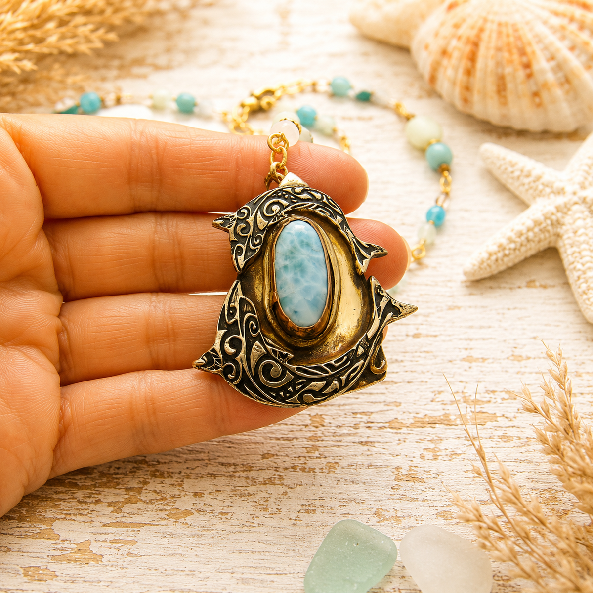 Handmade Larimar dolphin necklace featuring a solid bronze dolphin pendant, Caribbean blue Larimar, amazonite and jasper beads. Unique boho ocean jewelry.
