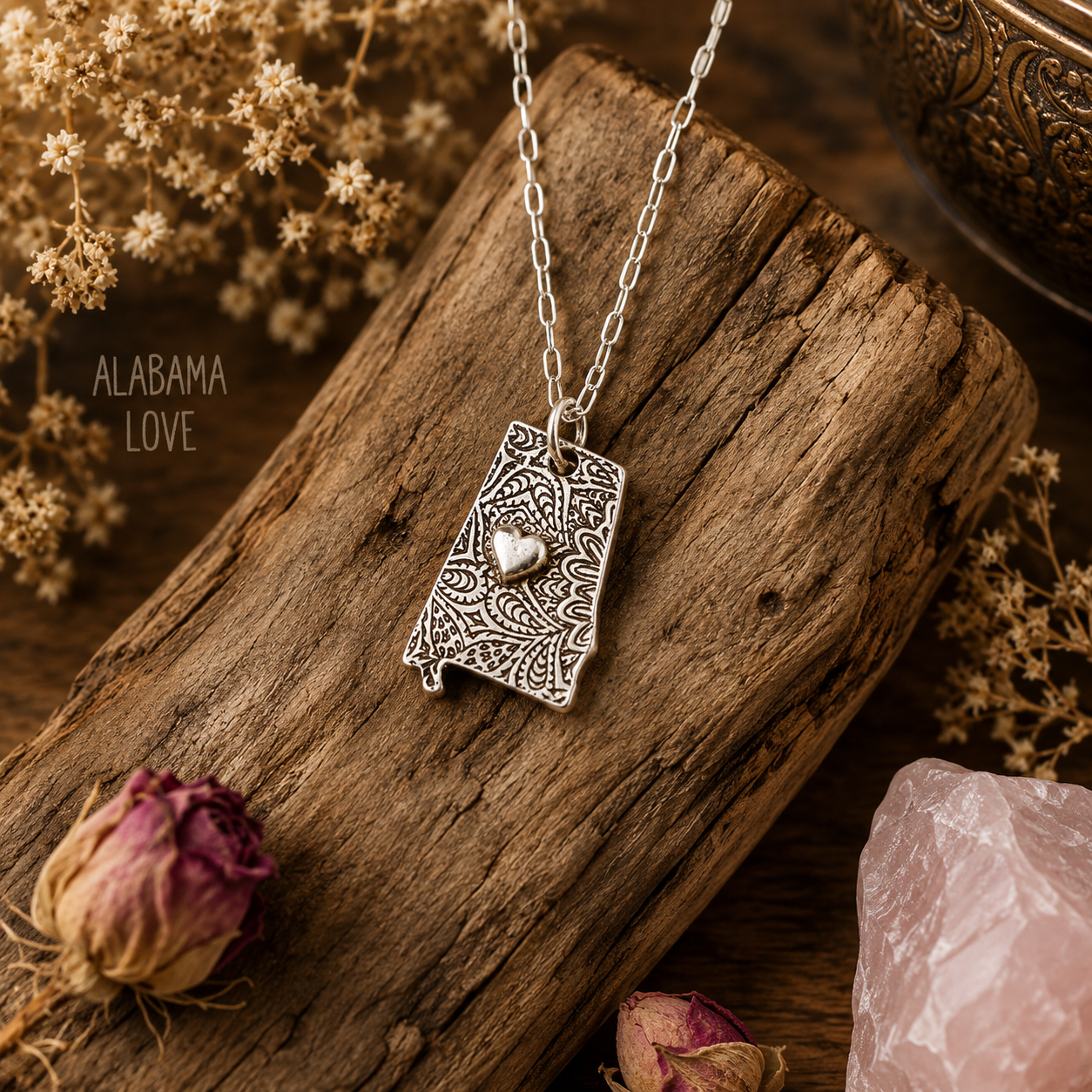 Shine your love for Alabama with this stunningly handcrafted and kiln-fired sterling silver necklace, featuring a delicate Alabama-shaped pendant with a heart in the center. Show off your state pride with a unique and fashionable piece of jewelry that is hallmarked as sterling silver and signed by CosmicDeva. Alabama love never looked so beautiful!