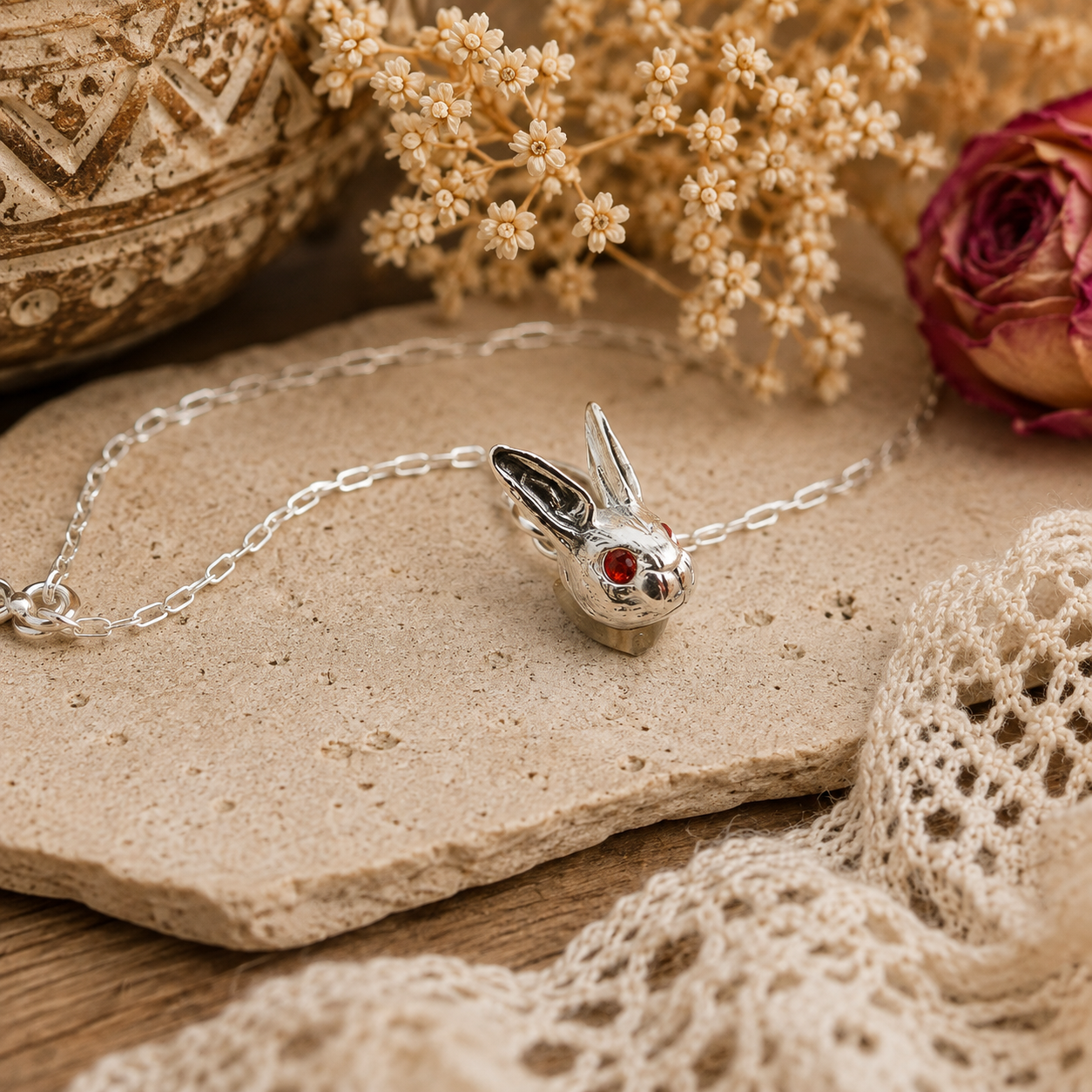 Dainty sterling silver bunny necklace with tiny fire opal eyes. Handmade rabbit pendant on an 18-inch silver chain—a sweet gift for bunny lovers.