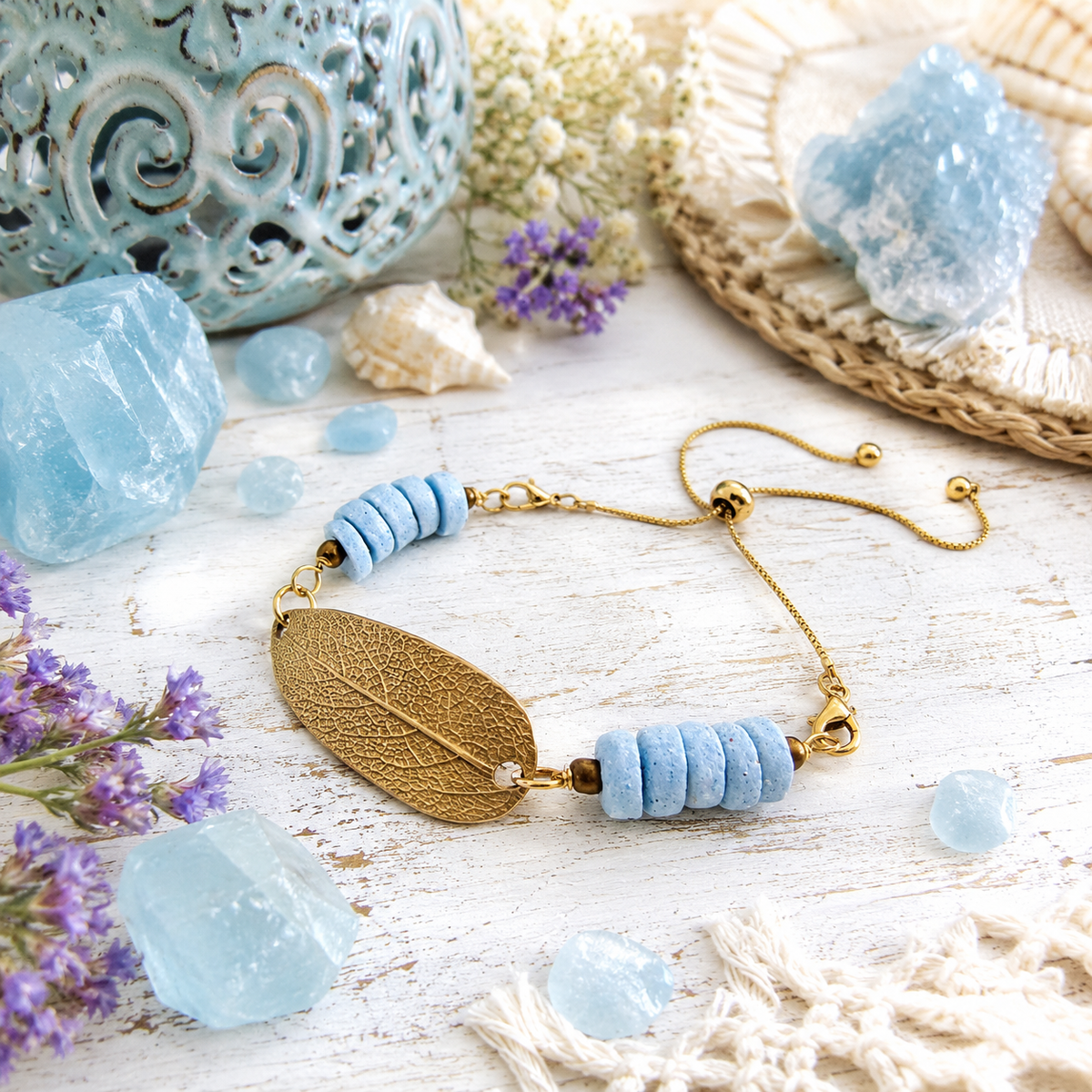 Handmade gold bronze sage leaf bracelet featuring a real botanical leaf imprint, Fair Trade aqua Ashanti glass beads and an adjustable slide clasp. By cosmicdeva 