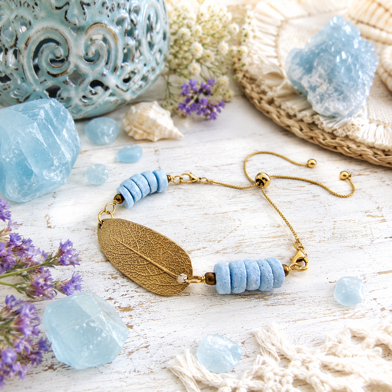 Handmade gold bronze sage leaf bracelet featuring a real botanical leaf imprint, Fair Trade aqua Ashanti glass beads and an adjustable slide clasp. By cosmicdeva 