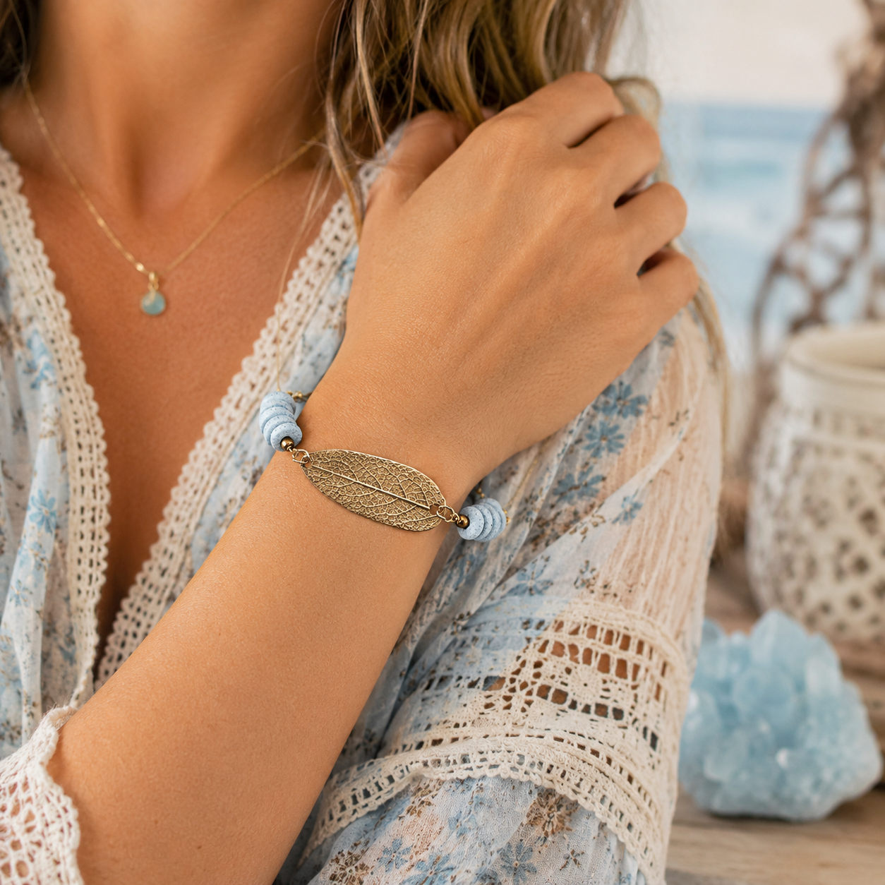 Handmade gold bronze sage leaf bracelet featuring a real botanical leaf imprint, Fair Trade aqua Ashanti glass beads and an adjustable slide clasp. By cosmicdeva 