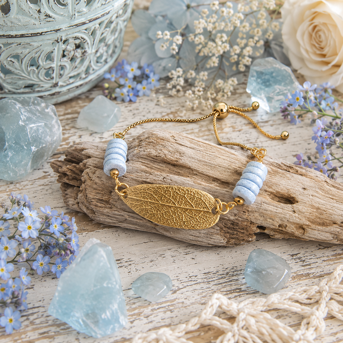 Handmade gold bronze sage leaf bracelet featuring a real botanical leaf imprint, Fair Trade aqua Ashanti glass beads and an adjustable slide clasp. By cosmicdeva 
