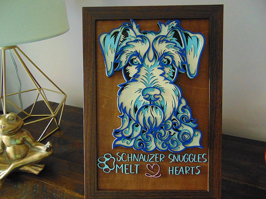 The Schnauzer Dog Wall Décor “SCHNAUZER SNUGGLES MELT HEARTS” comes with a wooden frame and is a unique addition to any dog lover's home. The wooden frame can stand on table, drawer or can hung up on wall.&nbsp;  Each piece is lovingly handcrafted, ensuring a one-of-a-kind piece of art. Our 3D Schnauzer design is made of 5 layers of wood and features a beautiful blue and white color scheme, making it a standout in any room.