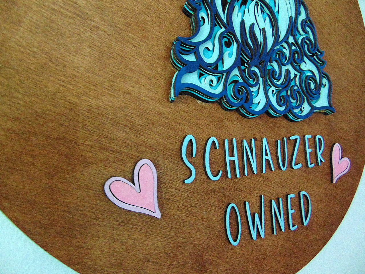 The Schnauzer Dog Wall Décor is a unique addition to any dog lover's home. Each piece is lovingly handcrafted, ensuring a one-of-a-kind piece of art. Our 3D Schnauzer design is made of 5 layers of wood and features a beautiful blue and white color scheme, making it a standout in any room. Ideal as a gift, we are happy to include a handwritten card with your personal message. Simply provide the details in your checkout notes.