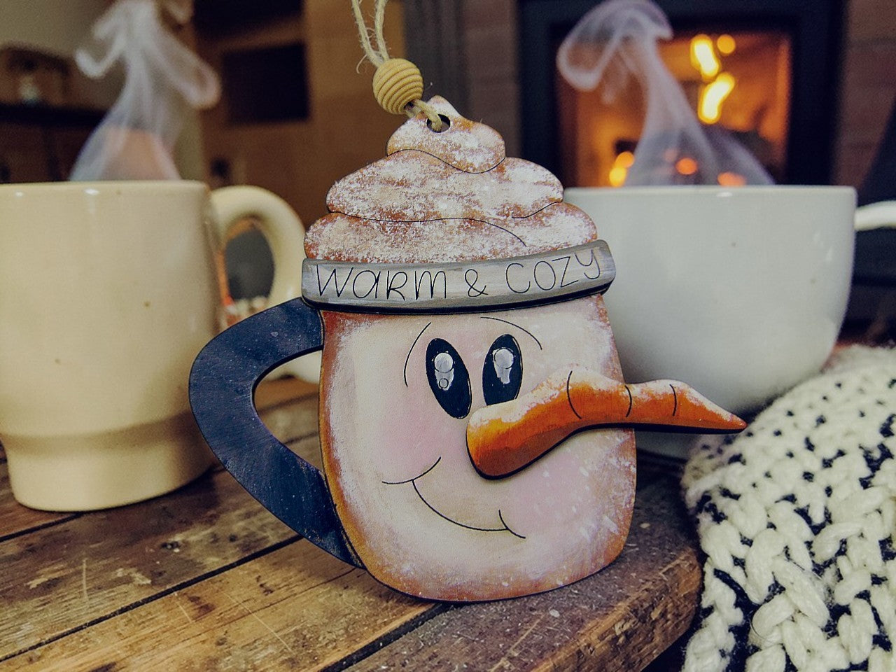 Hand painted wooden Snowman Coffee Mug Christmas Ornament. Cozy engraved mug design. Lightweight, durable, and perfect for holiday décor or gifting.