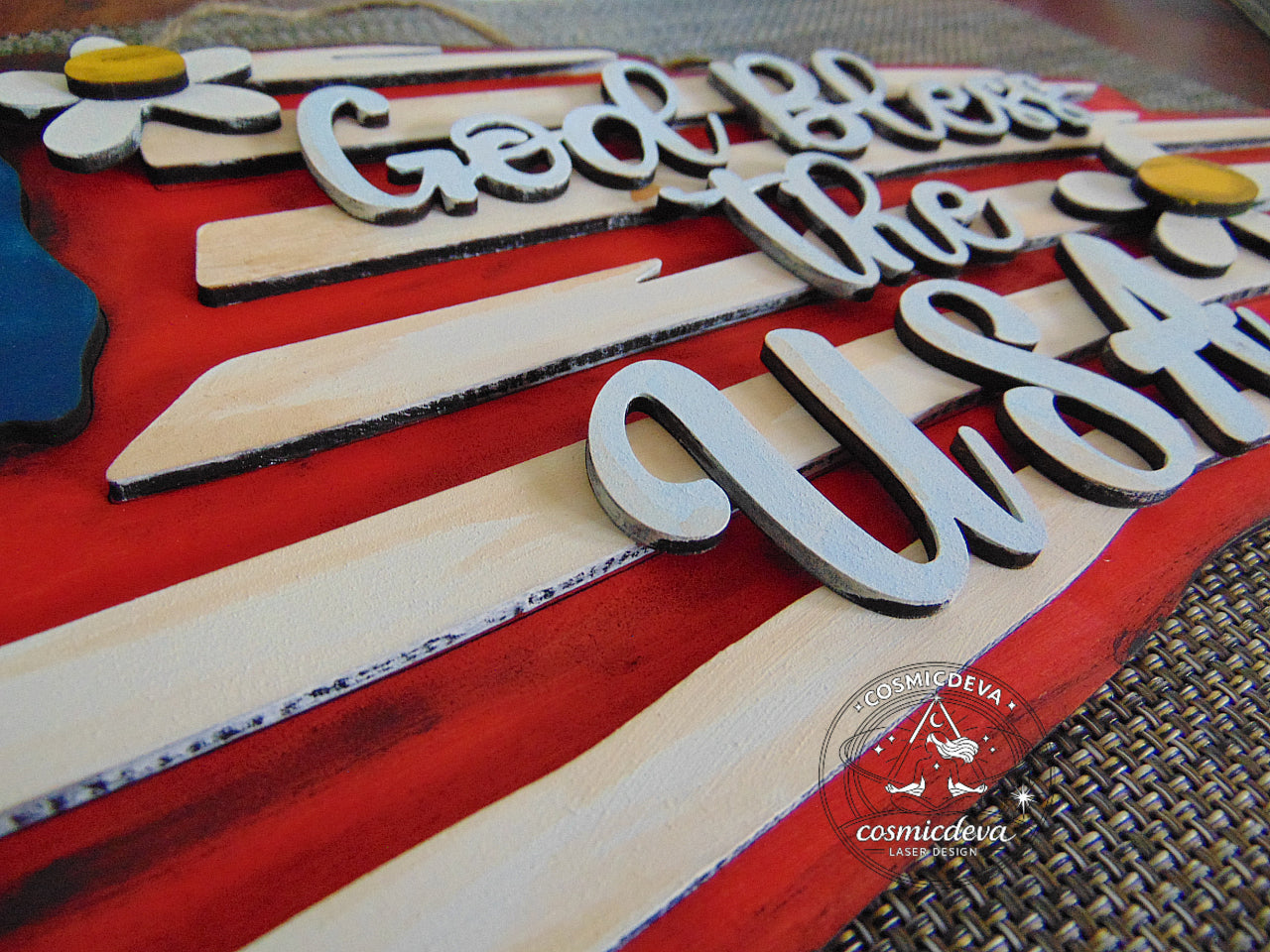 Handmade rustic American flag wall sign with layered laser-cut wood, distressed paint, and raised “God Bless the USA” lettering. Patriotic farmhouse décor perfect for July 4th or gifting.