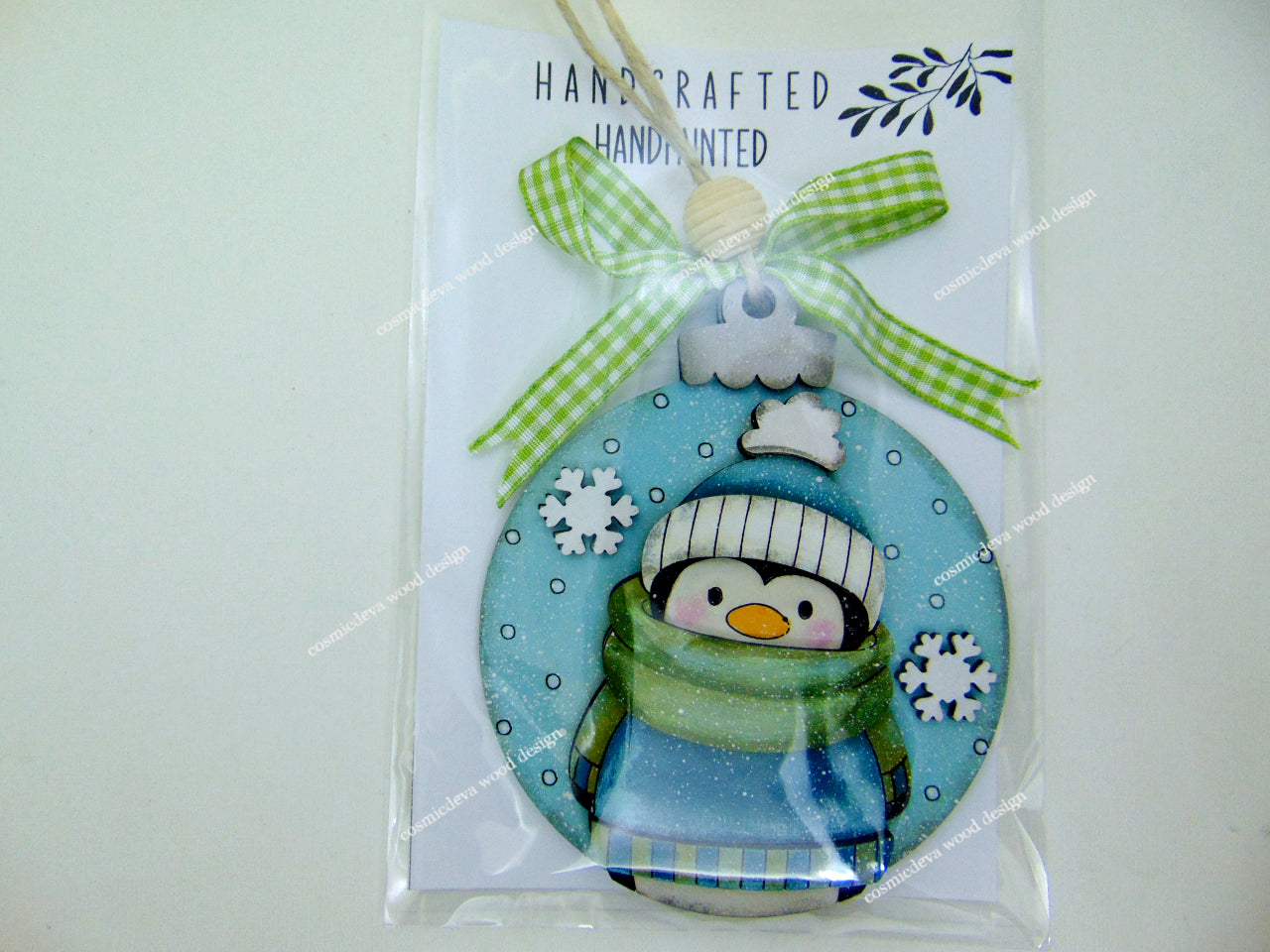 Hand painted Penguin Sweater Scarf Ornament featuring a cute bundled up penguin. Cozy layered birchwood Christmas décor ideal for trees, garlands, gift tags, and festive winter decorating.