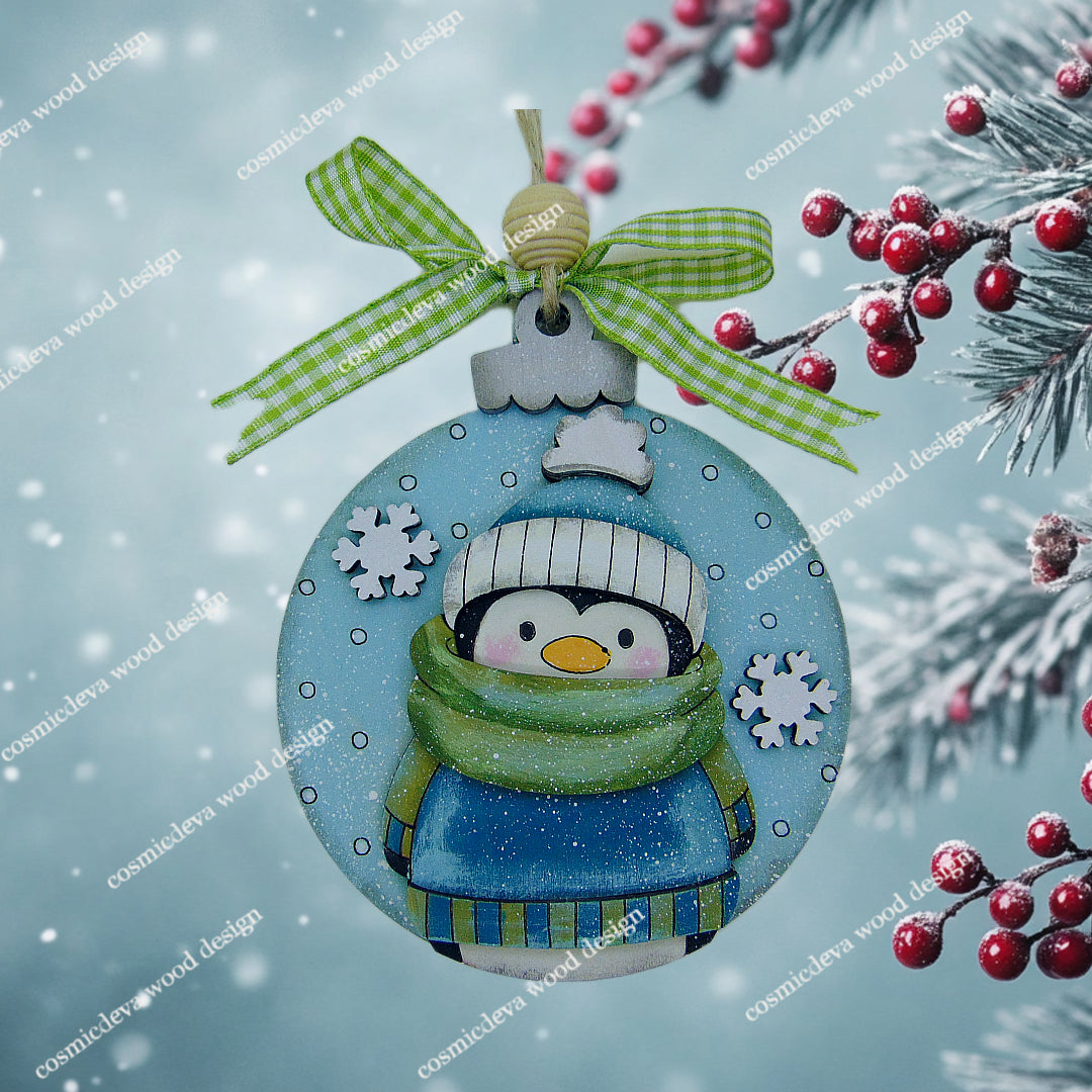 Hand painted Penguin Sweater Scarf Ornament featuring a cute bundled up penguin. Cozy layered birchwood Christmas décor ideal for trees, garlands, gift tags, and festive winter decorating.