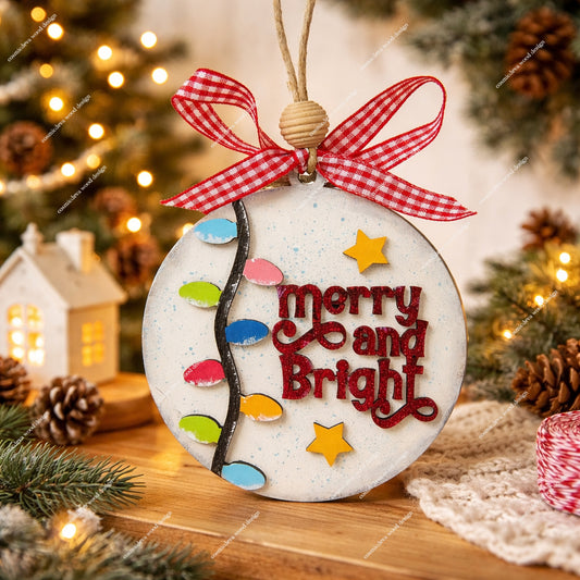 Hand painted layered birch wood Christmas ornament featuring fairy lights, stars, and “Merry & Bright” text. Rustic jute cord, handmade bow, and gift ready packaging. Lightweight, durable holiday décor.