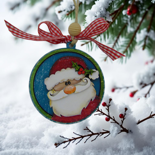 Hand painted wooden Santa ornament with holly, red berries, checkered bow and light blue background. Handmade rustic Christmas tree décor and holiday gift.