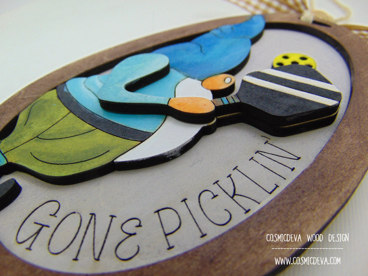 Hand painted 3D Pickleball Gnome Ornament with blue cap. Layered birch wood décor for year round pickleball lovers. Great gift for players, coaches, and fans.