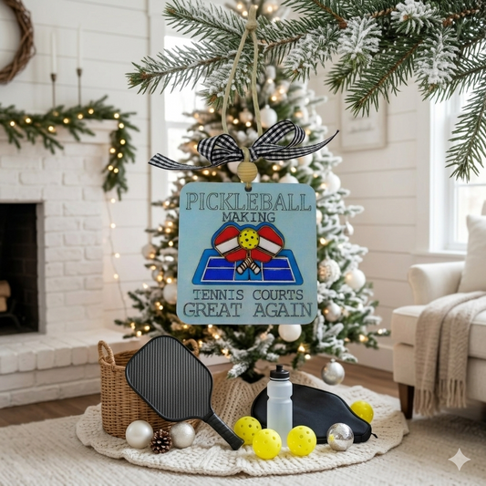 Celebrate the sport you love with this handcrafted Pickleball Ornament featuring the engraved phrase “Pickleball making tennis courts great again” and a 3D layered wood court with crossed paddles. Laser cut, hand painted, double sided, and gift ready—perfect for pickleball players, fans, and holiday décor.