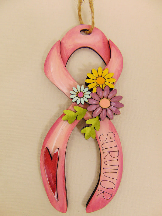 Hand painted wooden breast cancer survivor floral ribbon ornament with engraved “Survivor” text and layered heart. Meaningful pink ribbon awareness gift and inspirational keepsake.