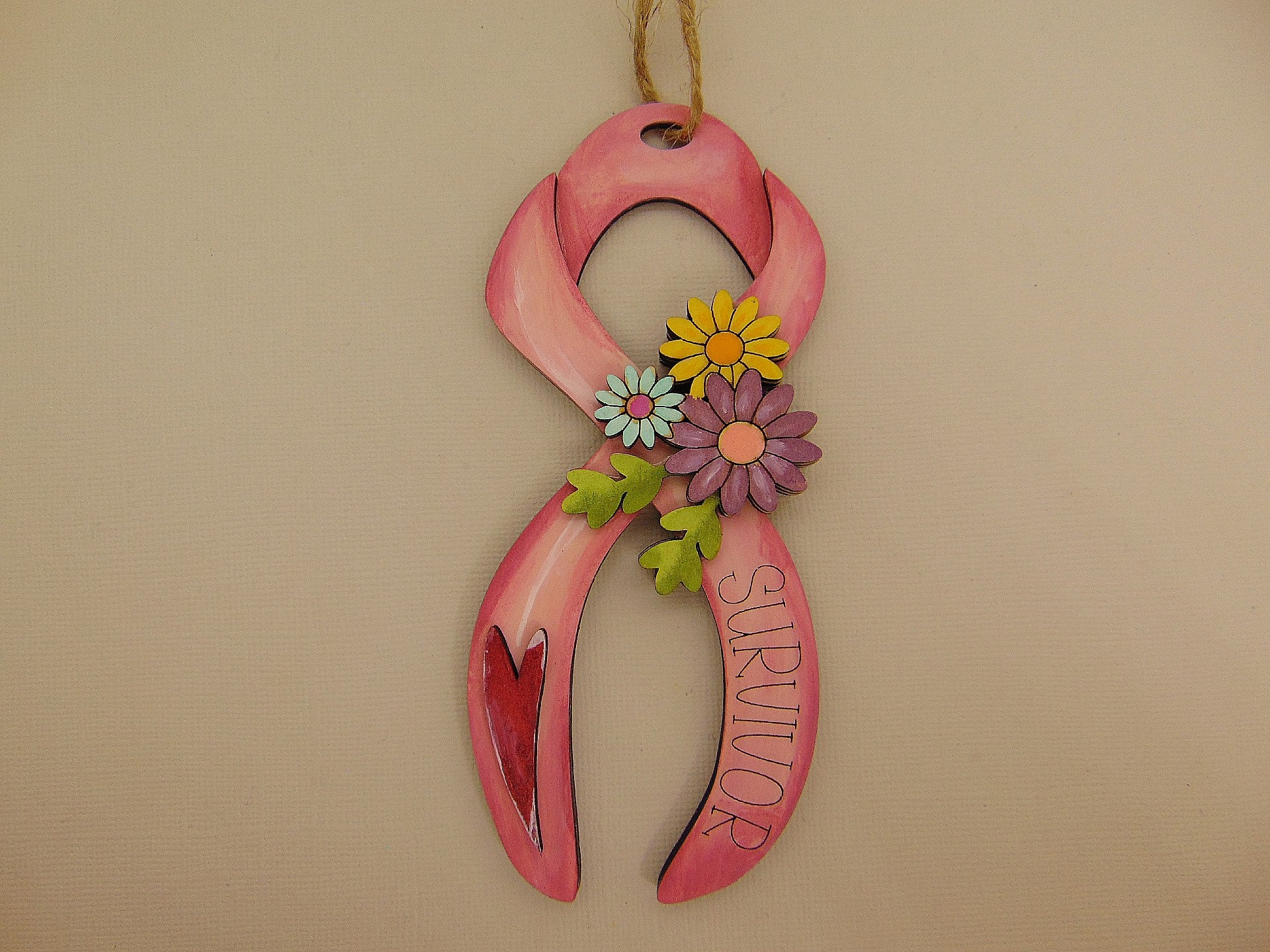Hand painted wooden breast cancer survivor floral ribbon ornament with engraved “Survivor” text and layered heart. Meaningful pink ribbon awareness gift and inspirational keepsake.