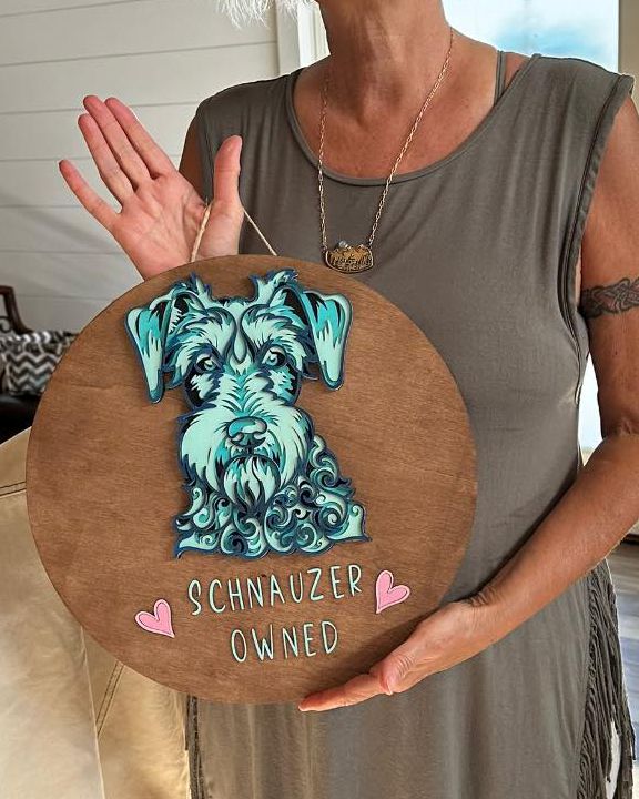 The Schnauzer Dog Wall Décor is a unique addition to any dog lover's home. Each piece is lovingly handcrafted, ensuring a one-of-a-kind piece of art. Our 3D Schnauzer design is made of 5 layers of wood and features a beautiful blue and white color scheme, making it a standout in any room. Ideal as a gift, we are happy to include a handwritten card with your personal message. Simply provide the details in your checkout notes.
