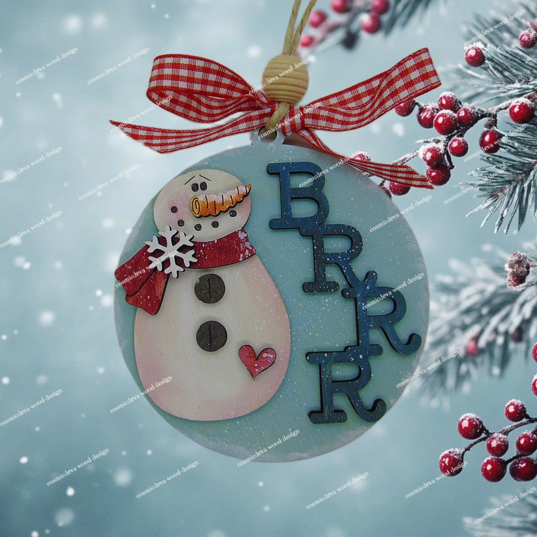 Add whimsical charm to your tree with our laser-cut Snowman Wood Ornament. Hand-painted with a red scarf and "Brrr" detail. High-quality 3.5" birch wood decor. Shop now!