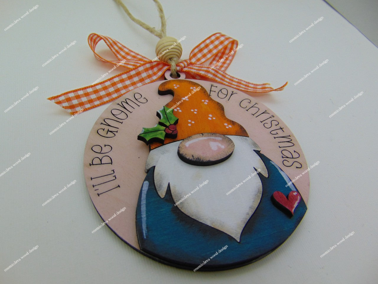 Handmade hand painted gnome Christmas ornament with engraved “I’ll Be Gnome for Christmas” text. Layered Baltic birch wood, rustic jute twine, wood bead, and bow. Cute holiday décor or gift.