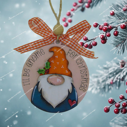 Handmade hand painted gnome Christmas ornament with engraved “I’ll Be Gnome for Christmas” text. Layered Baltic birch wood, rustic jute twine, wood bead, and bow. Cute holiday décor or gift.