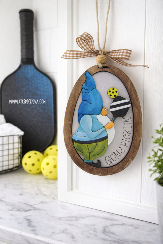 Hand painted 3D Pickleball Gnome Ornament with blue cap. Layered birch wood décor for year round pickleball lovers. Great gift for players, coaches, and fans.