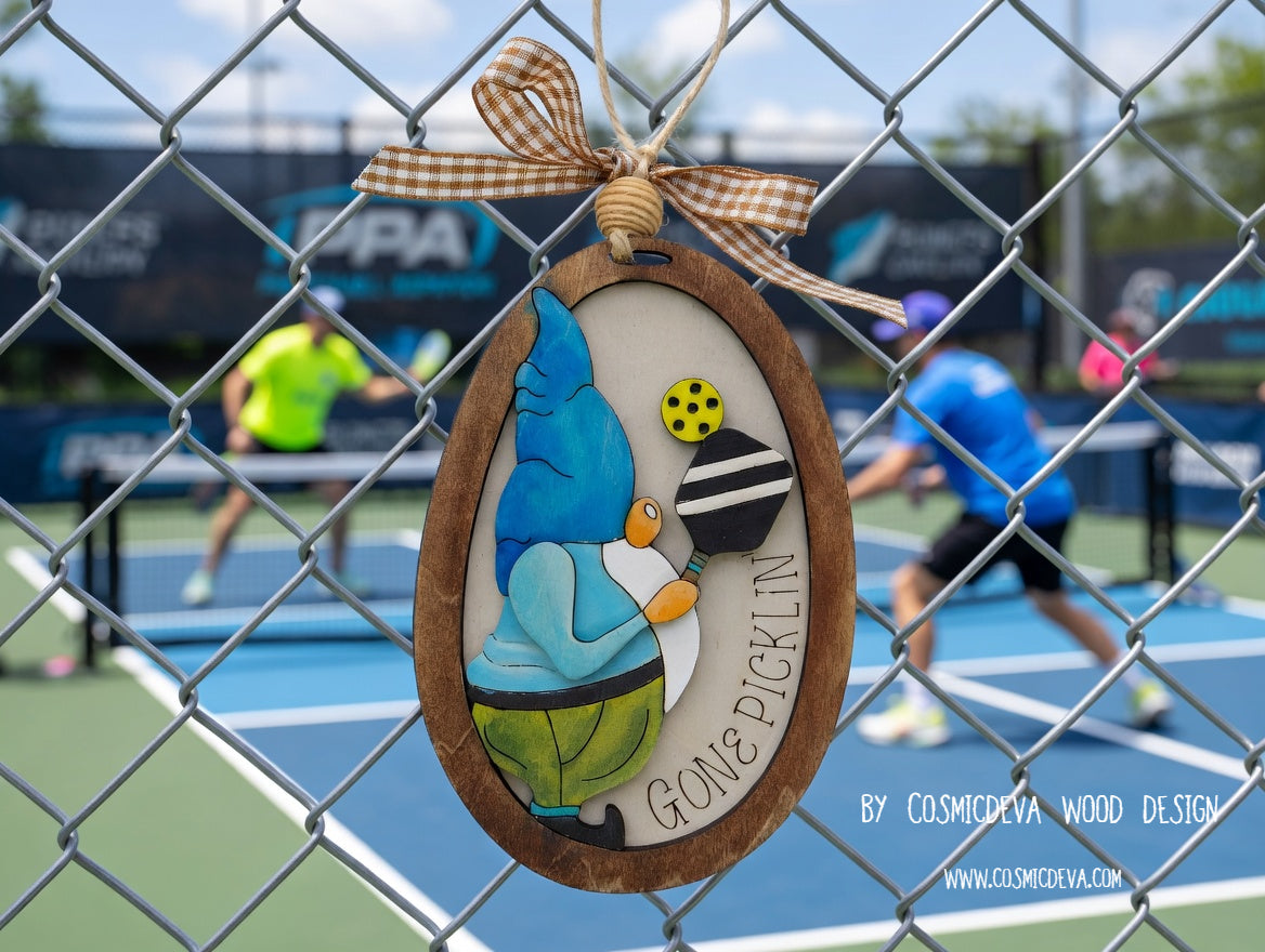 Hand painted 3D Pickleball Gnome Ornament with blue cap. Layered birch wood décor for year round pickleball lovers. Great gift for players, coaches, and fans.