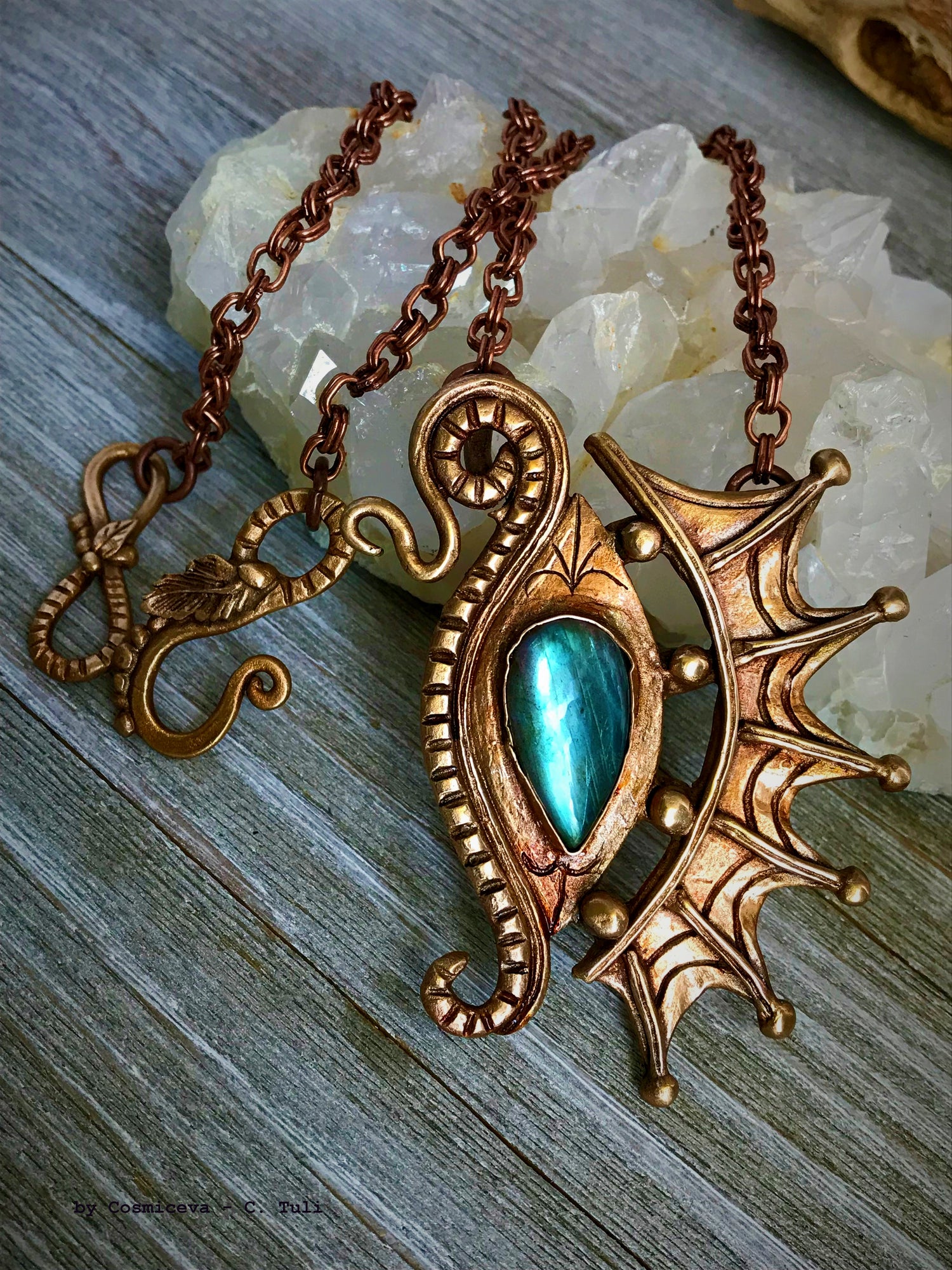 The Dragon is often seen as the guardian of a treasure. The treasure symbolizes you. This beautifully hand sculptured, carved, forged and kiln fired bronze pendant necklace symbolizes the Eye of a Dragon featuring a magical mystical shimmering labradorite gemstone. The reverse of the pendant is signed by the artist and carries the CosmicDeva brand hallmark.- CosmicDeva