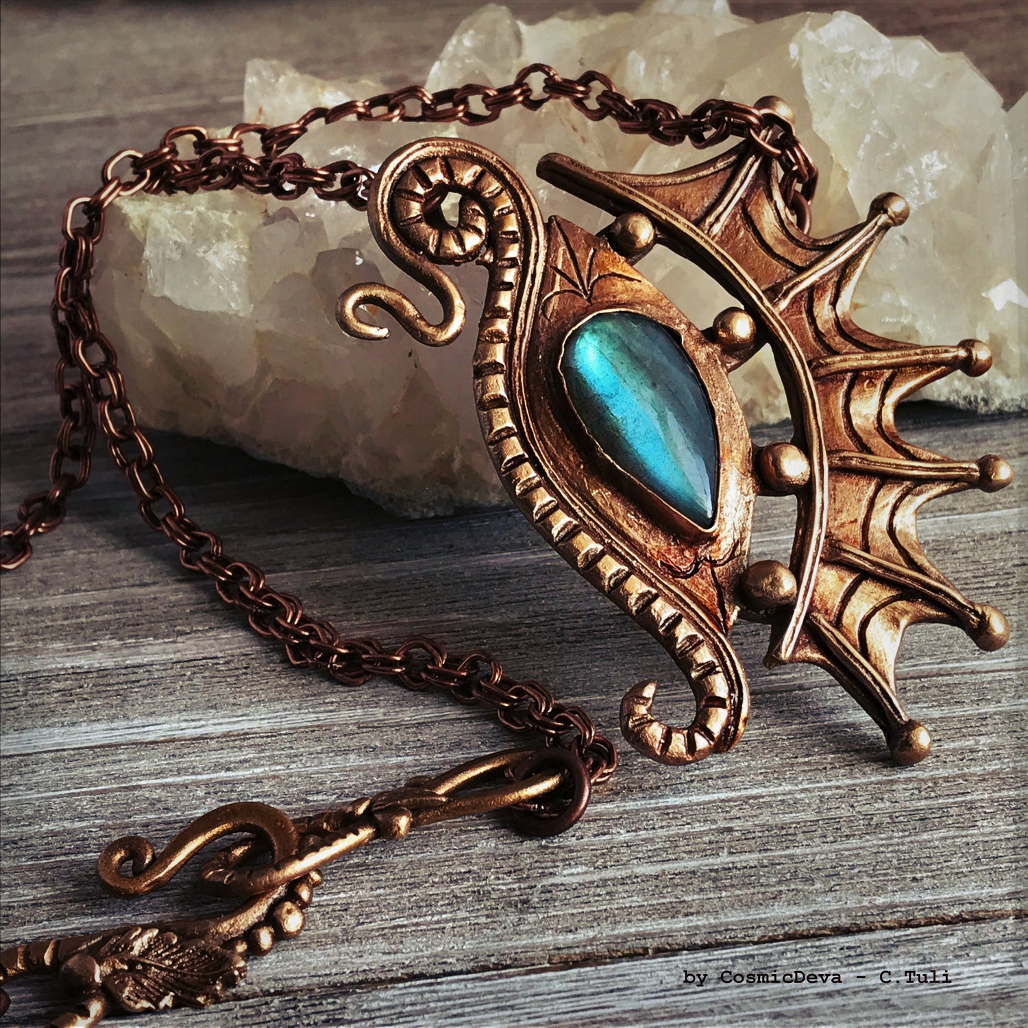 The Dragon is often seen as the guardian of a treasure. The treasure symbolizes you. This beautifully hand sculptured, carved, forged and kiln fired bronze pendant necklace symbolizes the Eye of a Dragon featuring a magical mystical shimmering labradorite gemstone. The reverse of the pendant is signed by the artist and carries the CosmicDeva brand hallmark.- CosmicDeva